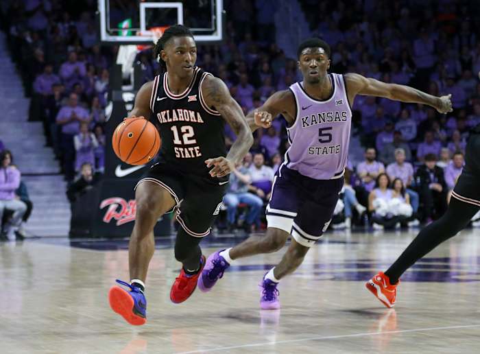 Jan 20, 2024; Manhattan, Kansas, USA; Oklahoma State Cowboys guard Javon Small (12) dribbles by Kansas State Wildcats guard Cam Carter (5) during the second half at Bramlage Coliseum. Mandatory Credit: Scott Sewell-USA TODAY Sports